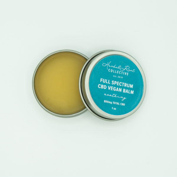 silver lip balm container with blue label by herbal root collective 2
