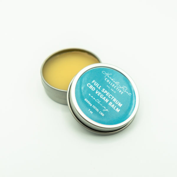 silver lip balm container with blue label by herbal root collective 3